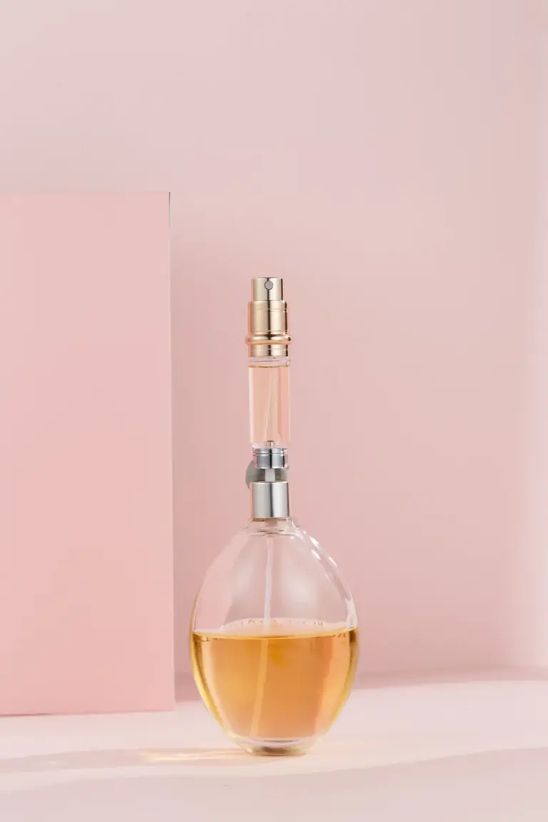 Bottom-fill perfume atomizer inner vial aligned with a perfume bottle stem for refilling