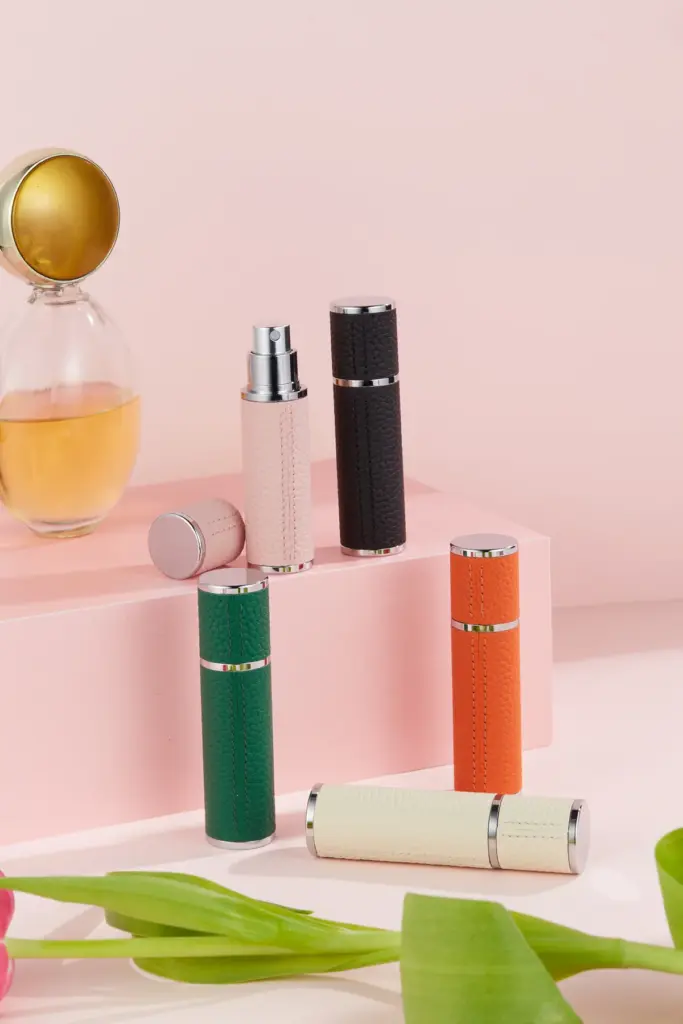 GOOD TEC leather-textured refillable perfume atomizers in pink, black, green, orange and ivory